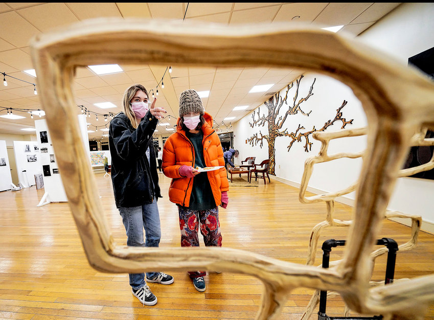 Lily Joiner, left, and Bella Ferreira, right, both sophomores at RISD, look over a sculpture carved out of plywood by RISD student Asher White.