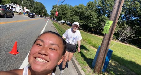 Larry Kessler trails his daughter Alana, who had already finished the Arnold Mills 4-Miler in 34:17 on the Fourth of July, as he heads to the finish line. He did the race in 58:41.&nbsp;Alana went back on the course to encourage her very slow father to finish the race.