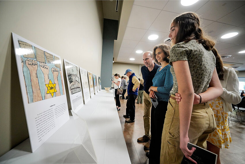 Attendees admire the art and writing contest winners.