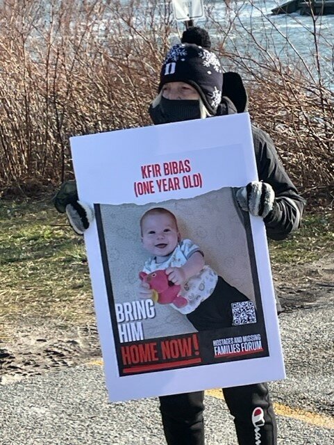 A group from the South County area participates in the &lsquo;Walk  a Mile for the Hostages&rsquo; event on the morning of Jan. 14, 2024, the  100th day of captivity for the hostages taken by Hamas from Israel to Gaza. Maysy Fricklas from Congregation Beth David, in Narragansett, holds the poster of Kfir Bibas, the youngest hostage.