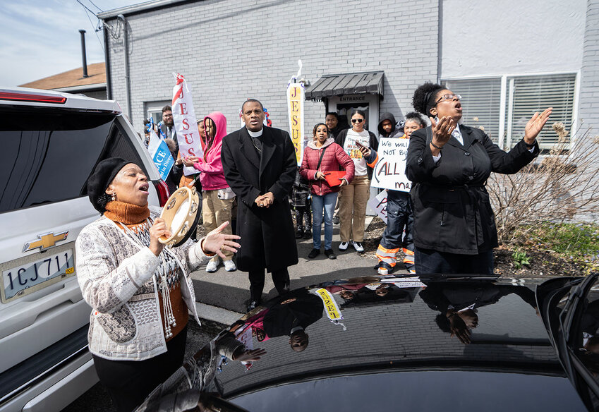 Pastor Nancy Perry, right, of Shiloh Gospel Temple Ministries, leads the group in song before the march began.