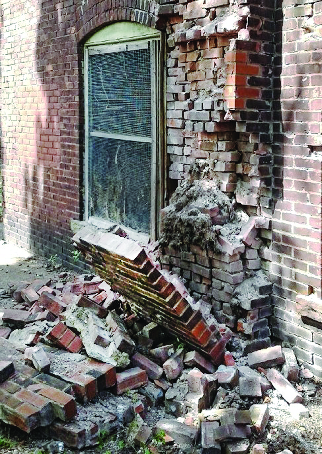 Before: The section of toppled brick on the side rear 
of the building.