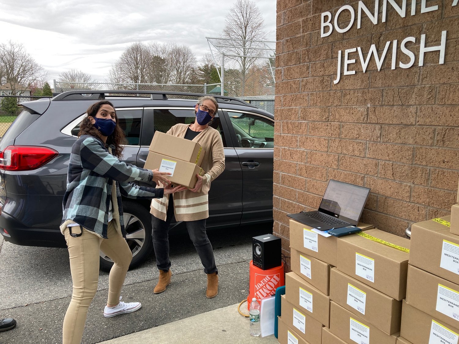 Rabbi Sarah Mack picks up her family's Israel boxes from Or Cohen.