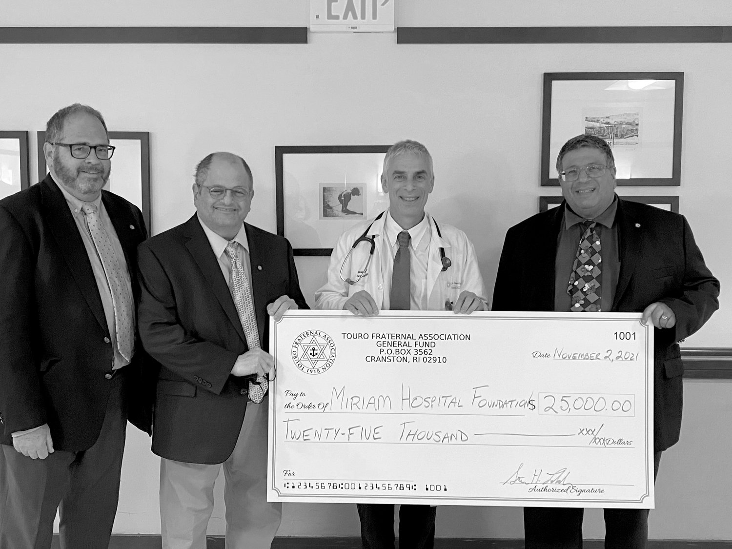 Dr. Howard Safran (second from right), chief of oncology at the Miriam Hospital, accepts a $25,000 donation from Touro Fraternal Association to the hospital's Center for Innovative Cancer Research.  Representing Touro are, from left, Jeffrey Davis, vice chairman of the board of directors; Barry Schiff, chairman of the Community Involvement Committee; and Stevan Labush, chairman of the board of directors.
