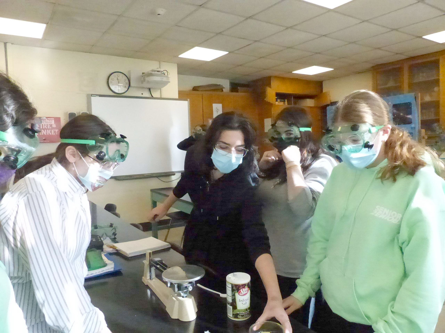New England Academy of Torah Seniors experiment in the school’s science lab.