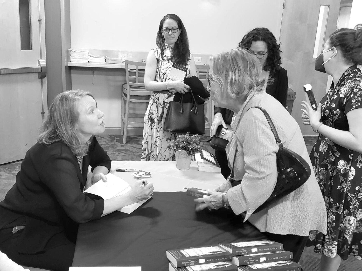 Meg Waite Clayton signs Sally Chorney's book.