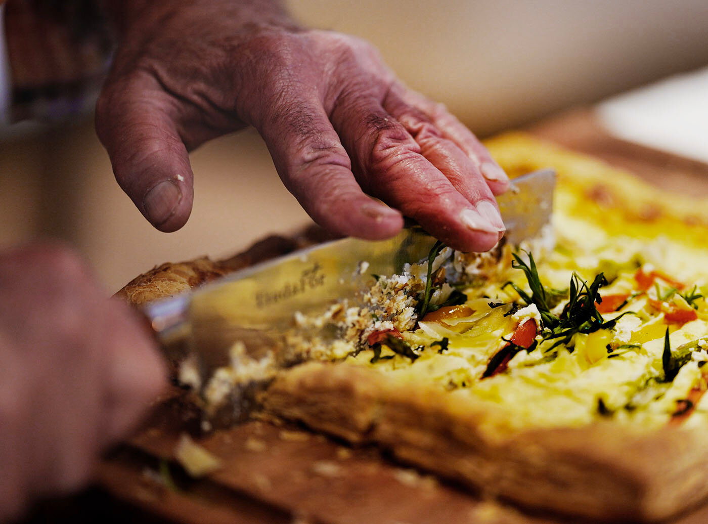 Philip Weinstein, of Westport Massachusetts, cuts his asparagus, goat cheese and tarragon tart.