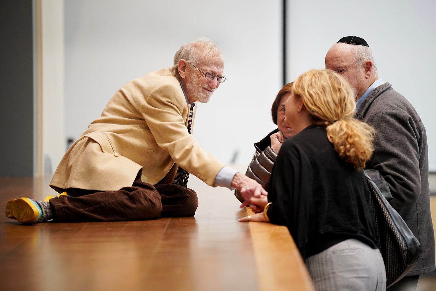 Mike Fink chats with a few community members after the Kristallnacht program on Nov. 9, 2023.