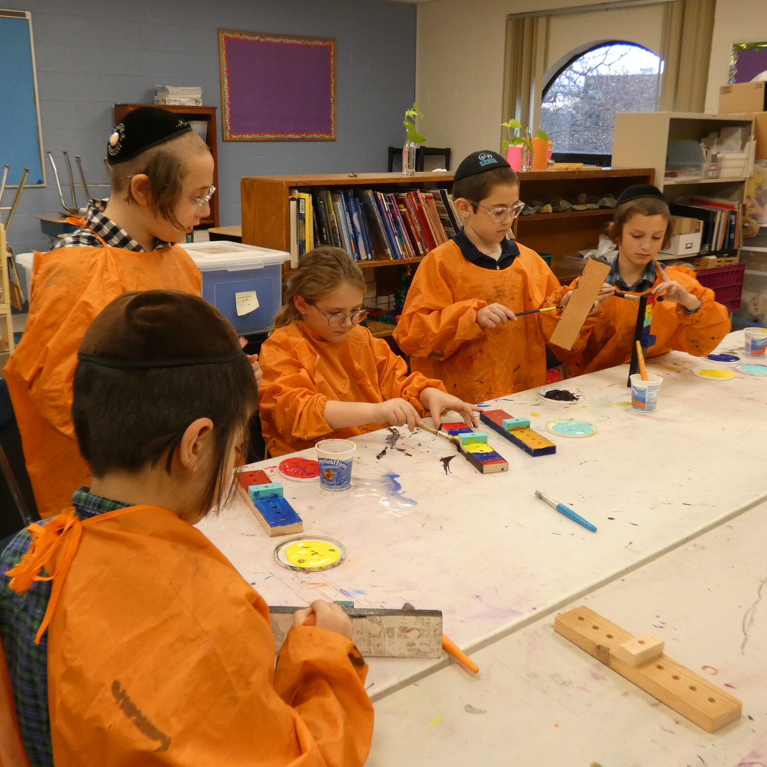 Providence Hebrew Day School students paint menorahs for Jewish Collaborative Services to distribute to local Jewish nursing home residents.