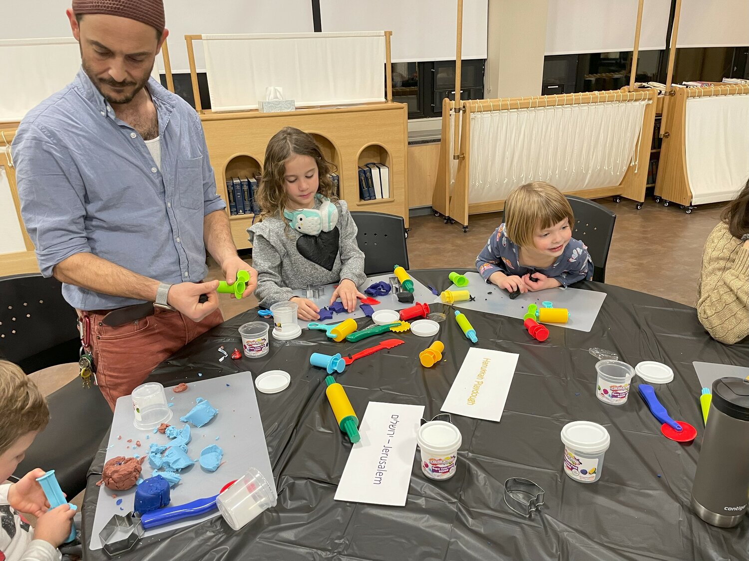 Families make playdough at a Hanukkah event sponsored by the Jewish Alliance of Greater RI.