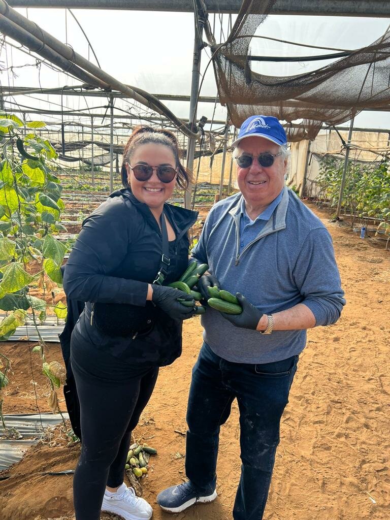 Sydney Miller and Dr. Robert Ducoff with some of what they helped to pick at a farm in Israel.