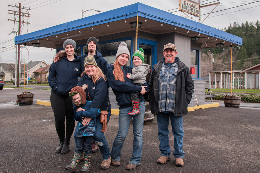 From left, Brenna Kinsey and Kyle Dyer, Lottie Dyer, with Aryelle Newton and her kids, and Michael Dyer smile and pose for a photo outside Harold&rsquo;s Burger Bar located at 727 South Gold Street in Centralia.