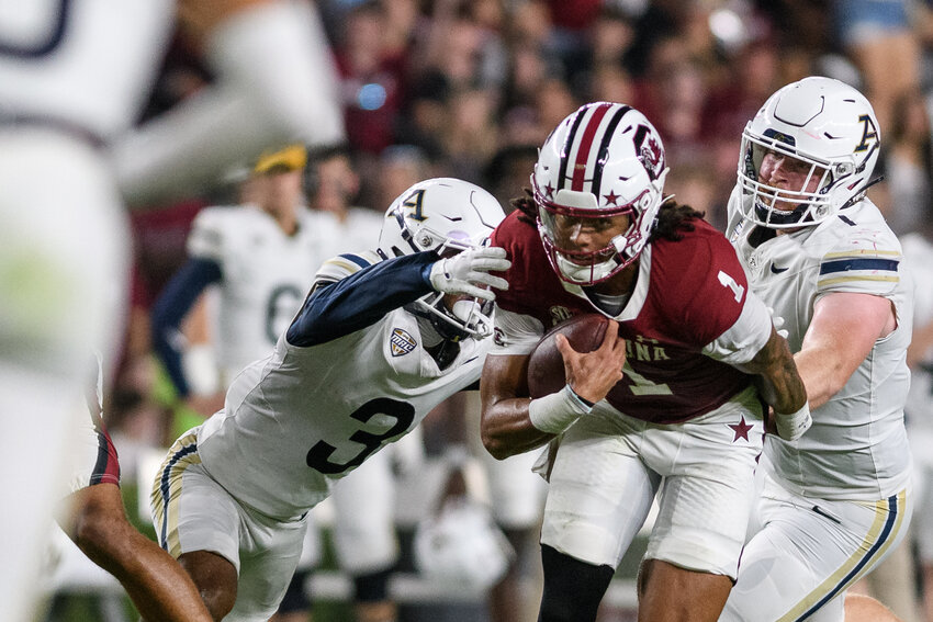 South Carolina quarterback Robby Ashford (1) carries the ball as Akron cornerback Devonte Golden-Nelson (3) attempts a tackle during the first quarter at Williams-Brice Stadium in Columbia, S.C., on September 21, 2024.