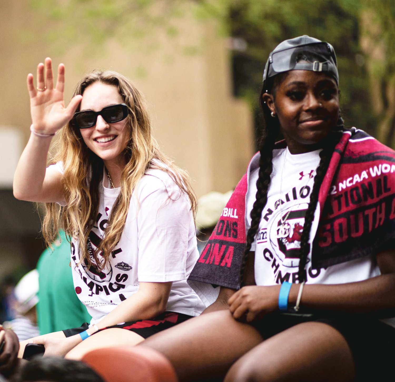 Lexington High School graduate and University of South Carolina guard Olivia Thompson waves to the crowd from one of the vehicles used during the team parade.