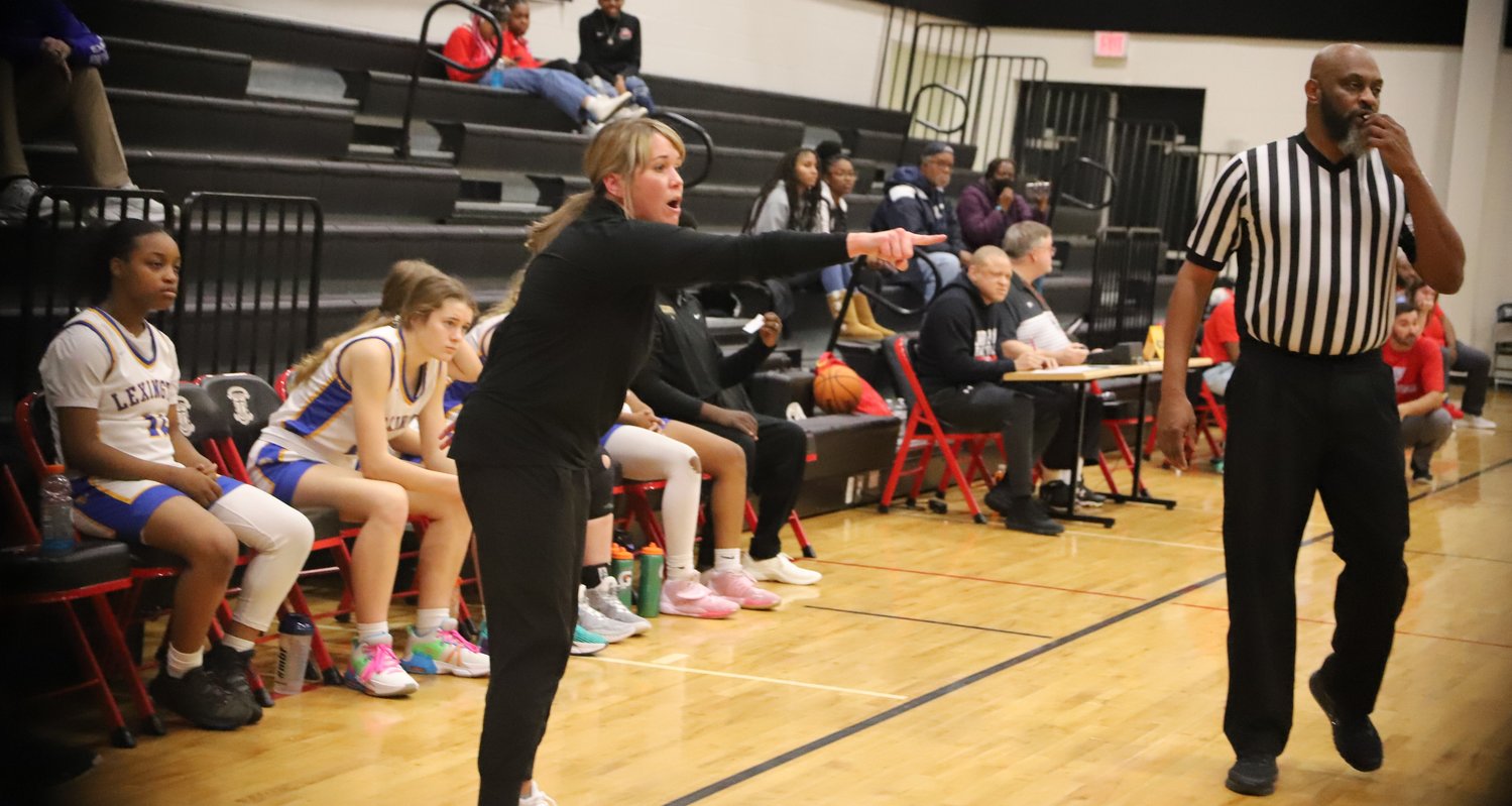 Lexington girls' basketball coach Molly Goodrich points out instructions.