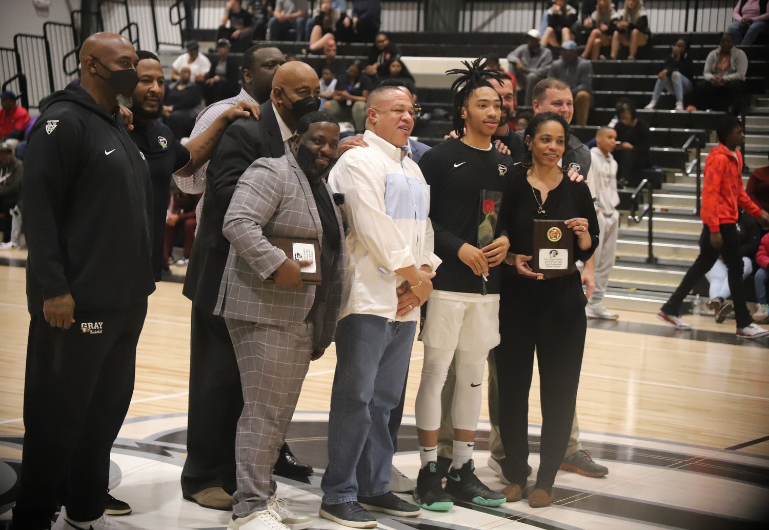 Gray Collegiate guard Mychael Mitchell, his family and the coaching staff during Senior Night ceremonies.