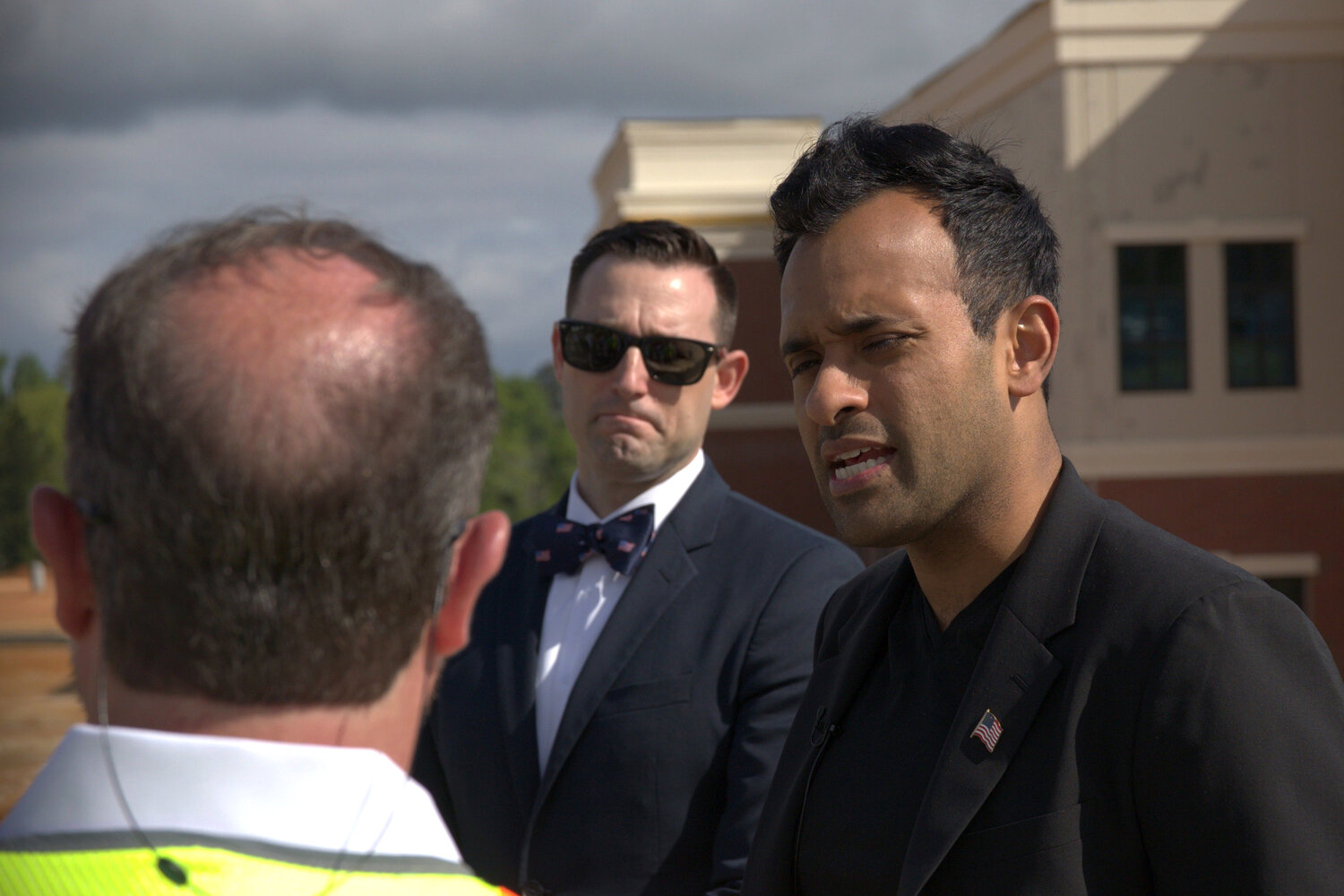 Republican presidential hopeful Vivek Ramaswamy talks with officials at Lexington's American Leadership Academy before a tour of the in-progress school April 28.
