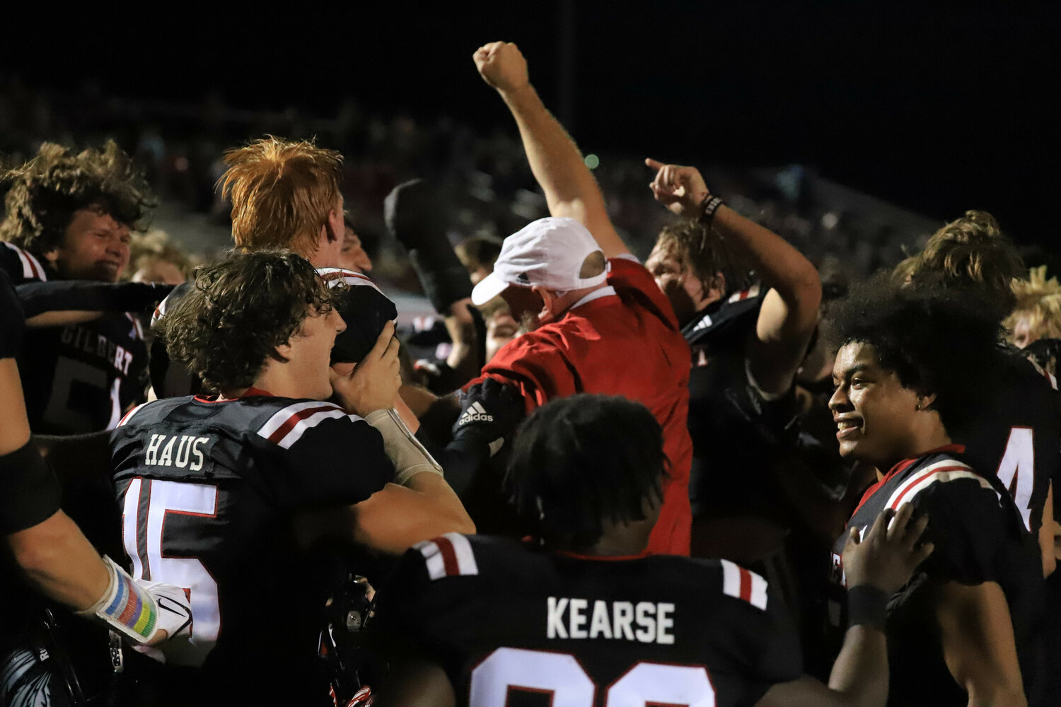 Gilbert head coach Chad Leaphart celebrates with his team after their 14-3 win over Lexington.