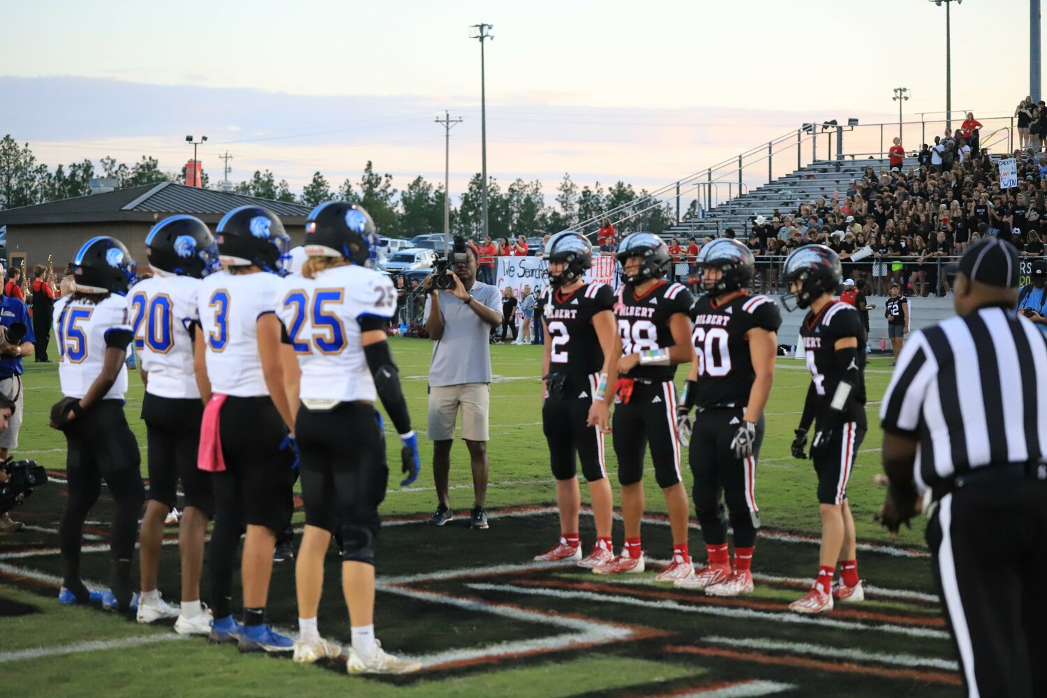 Lexington and Gilbert meet at midfield for the pregame coin toss.