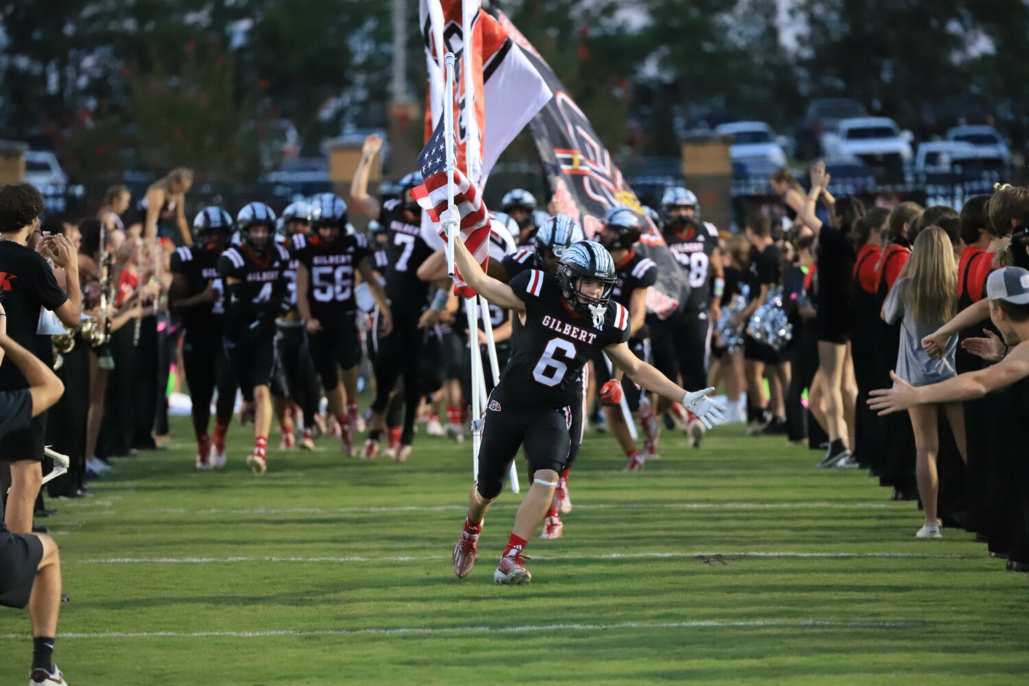 CJ Browning leads Gilbert on to the field before their 14-3 upset win over Lexington.