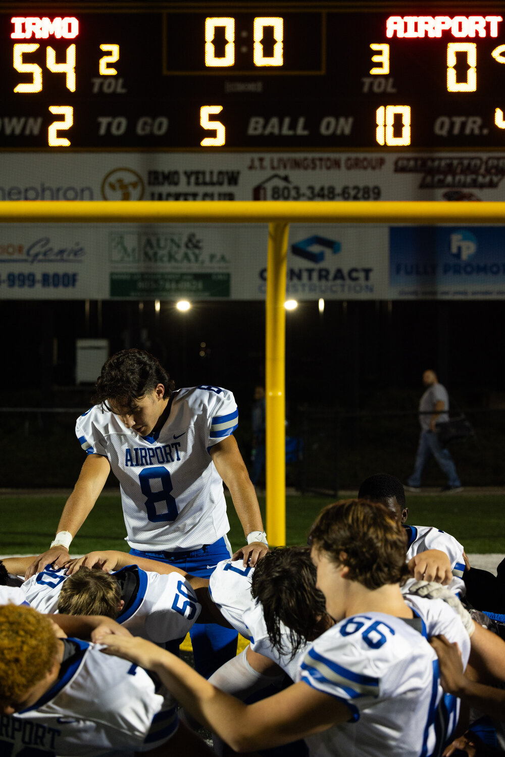 Airport Eagles quarterback Jesse Hoover leads his team in prayer after a difficult loss to the Irmo Yellow Jackets.