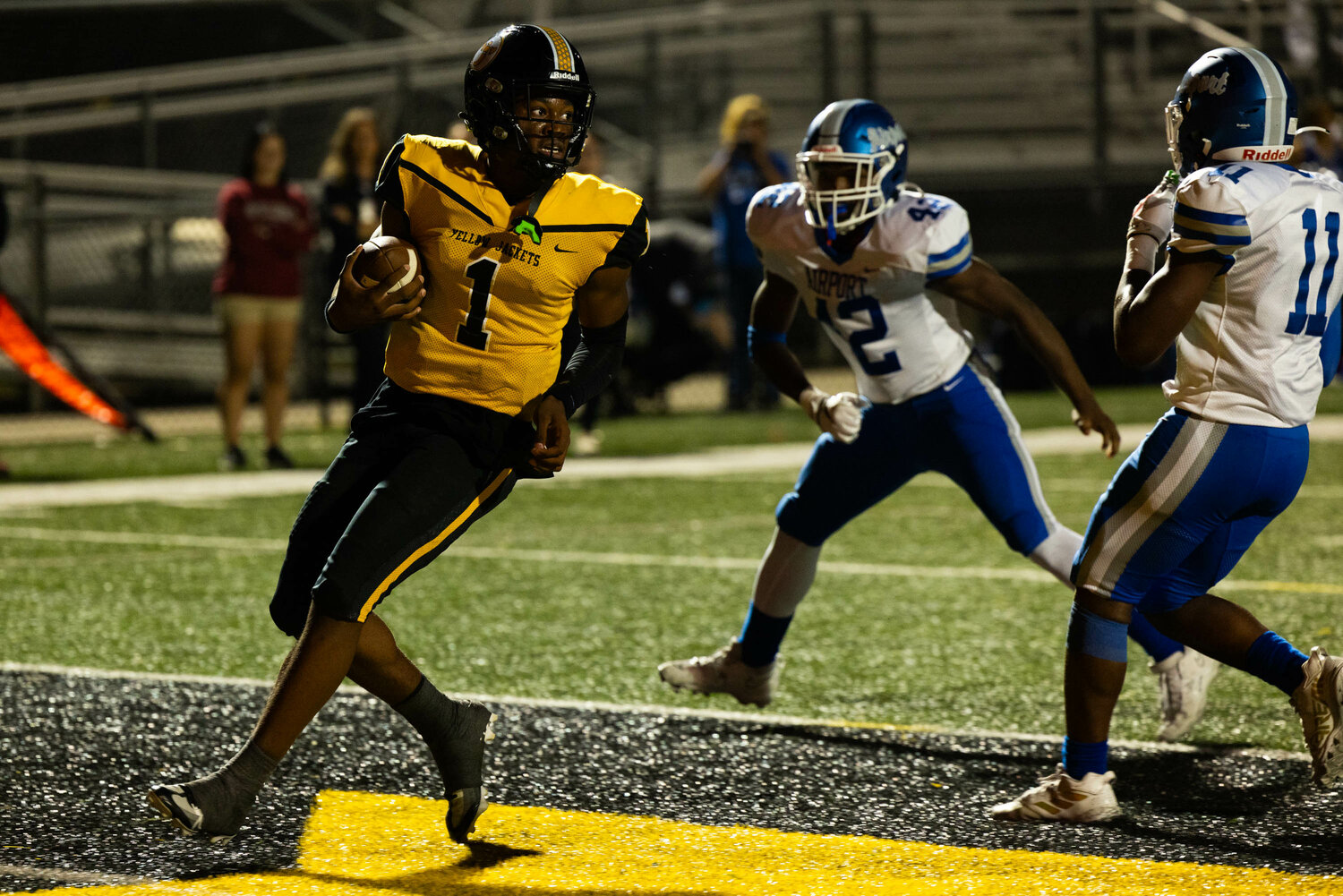 Yellow Jackets quarterback A.J. Brand rushes for a touchdown during the first quarter against the Eagles.