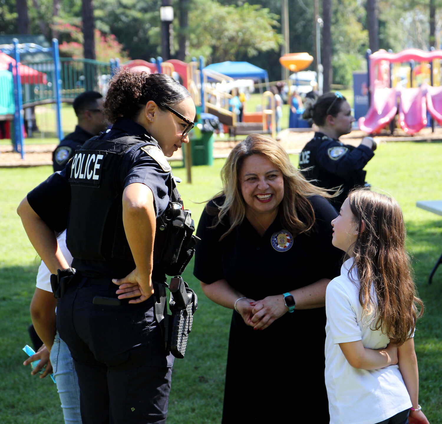 Juana Saavedra (center), victim advocacy/community outreach coordinator for the Cayce Police, talks with a child attending the Cayce Police Department’s second annual Fiesta Sept. 24. The event is part of the department’s growing efforts to reach out to the Hispanic community.