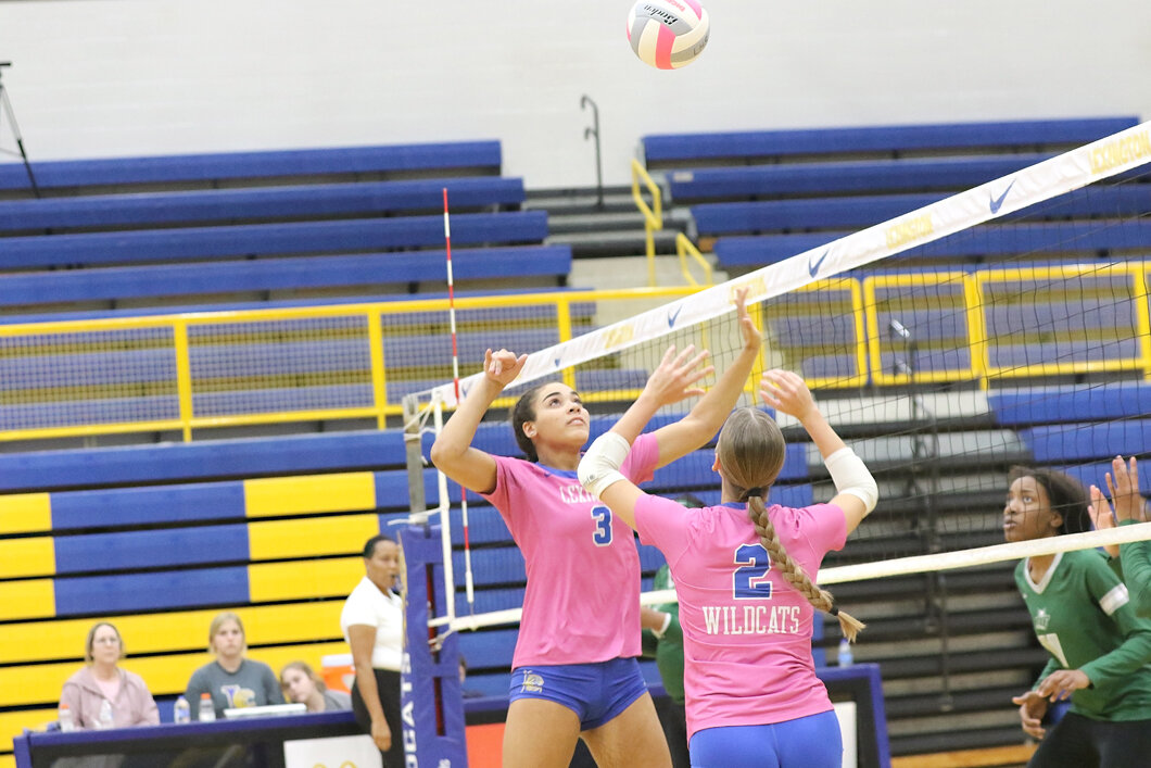 Jazlyn Snow and Sydney Fischer go up for a ball during their regular season finale against Dutch Fork.