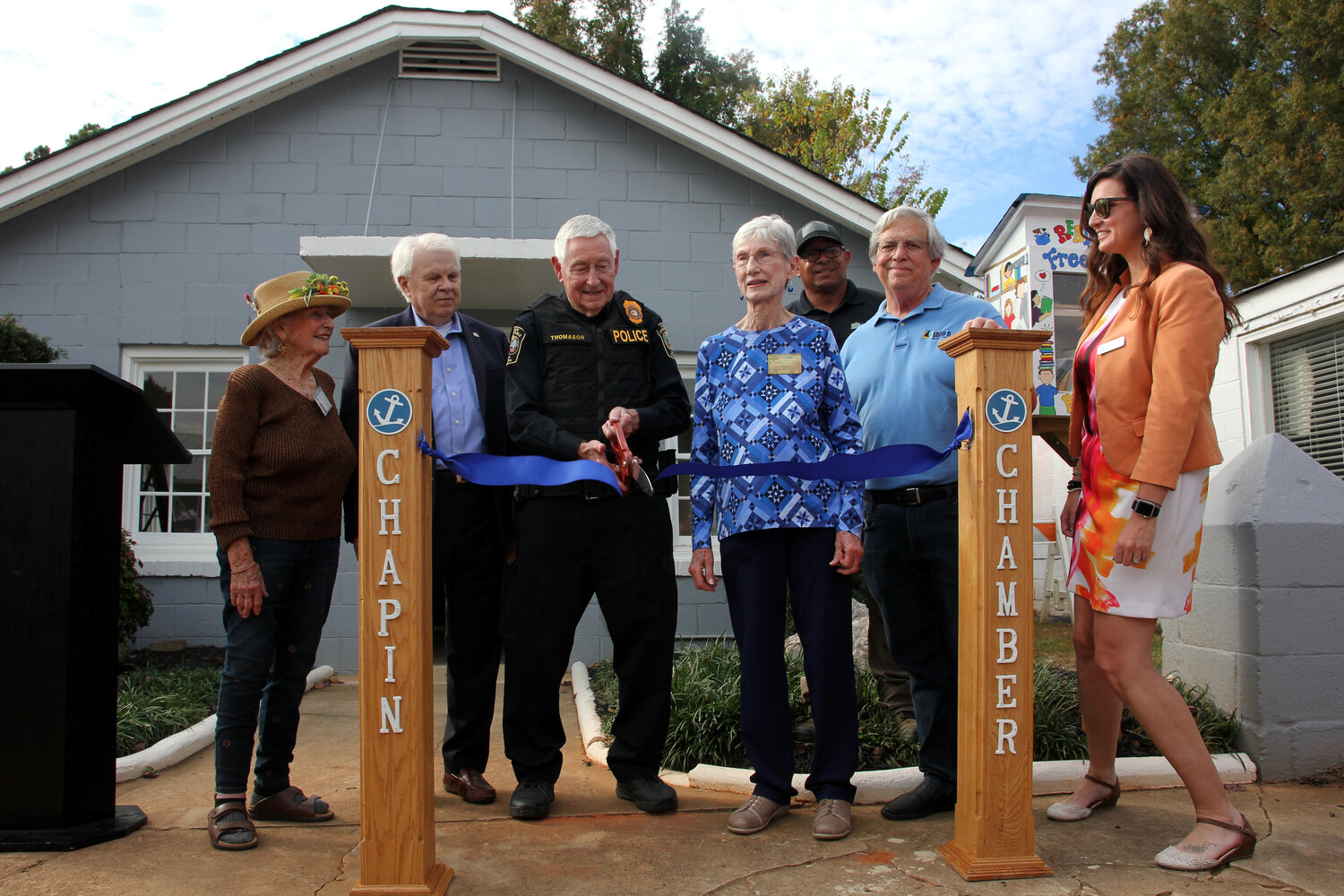 Officials, including Mayor Al Koon (second from left), Chapin Historical Association Secretary and Historian Pat Lewandowsky (middle) and Town Administrator Nichole Burroughs (right), cut the ribbon at the unveiling of Chapin's newly renovated original town hall