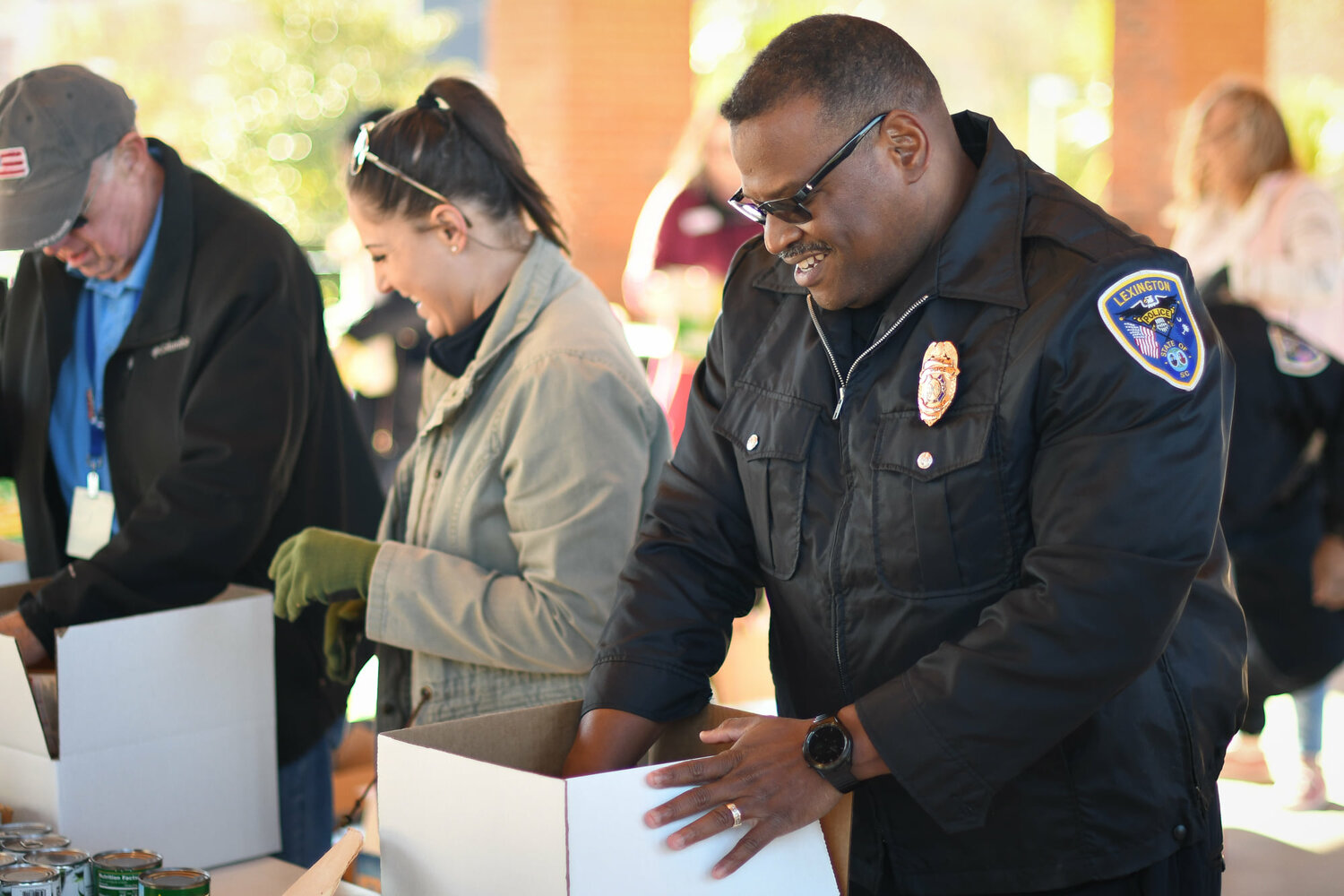 Lexington Police Chief Terrence Green helps pack boxes at Bountiful Harvest, which returns for another year Nov. 21.