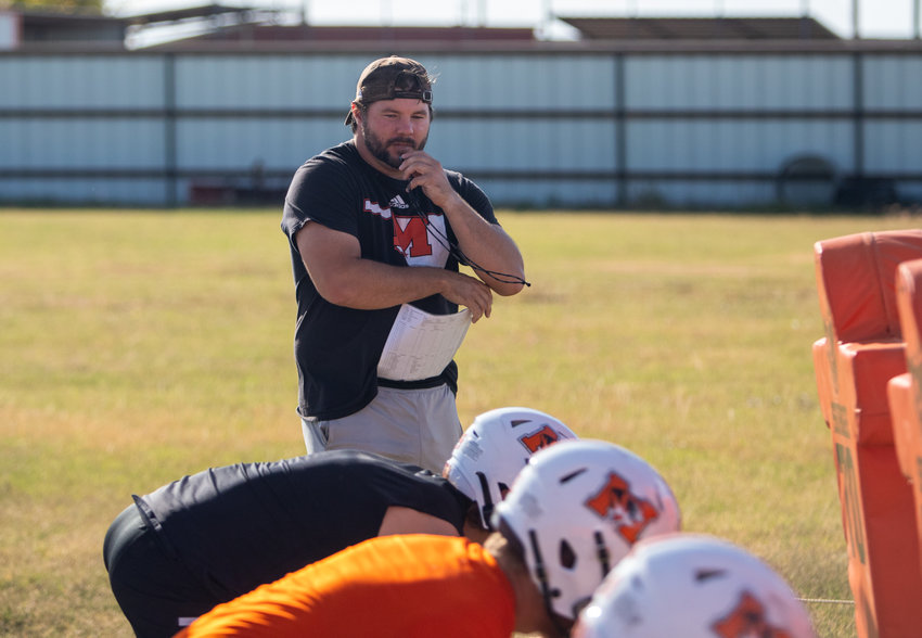 Tigers Head Coach Sam Powers works with his defensive line during Monday&rsquo;s practice.