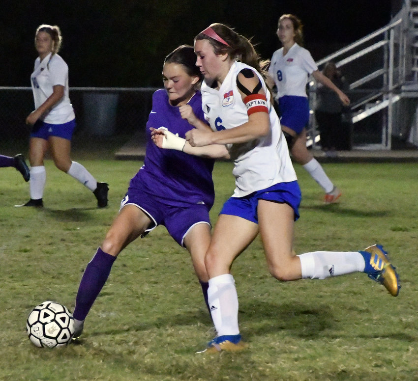 Sarah Woolbright (2) of the Viqueens and Addison Bunty (6) of the Lady Rockets battle for possession.