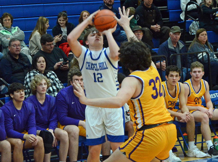 Forrest&rsquo;s Brennan Mealer (12) nails one of his four 3-pointers in the game for the Rockets, who fell 56-44 to the Community Vikings in Friday night&rsquo;s District 7-AA opener at Chapel Hill.