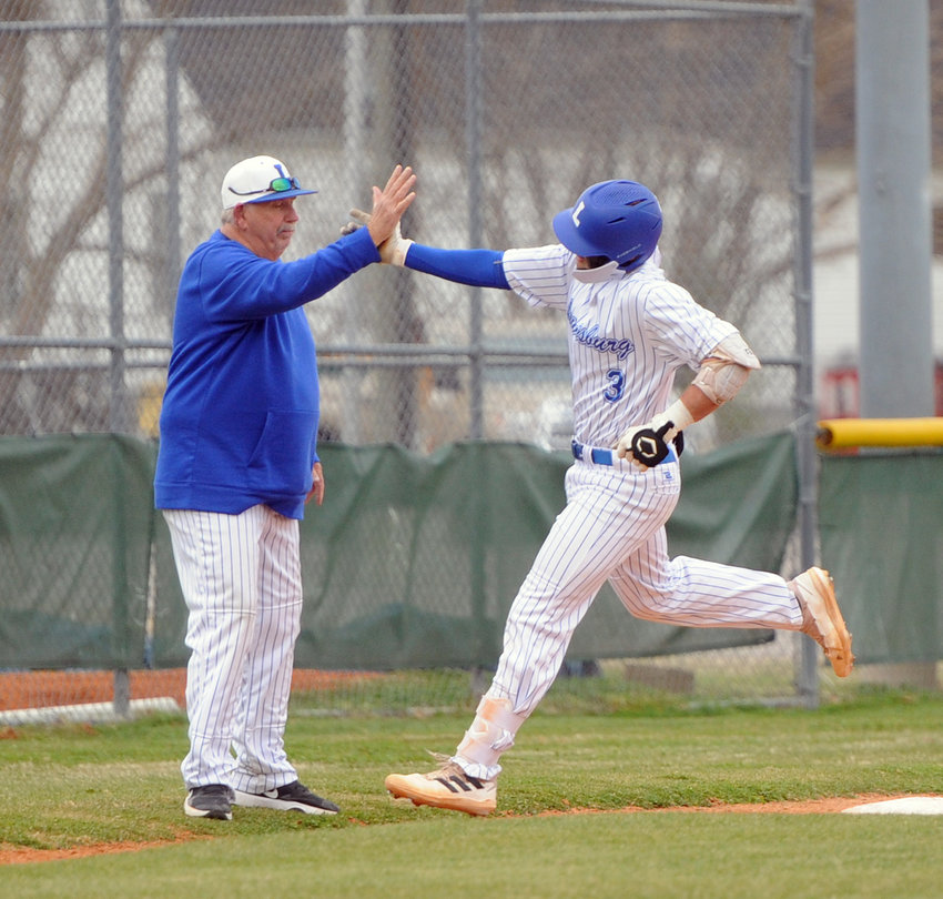 Tristan Griggs catches a high five from coach Mike &ldquo;Monk&rdquo; Reese  as he rounds third base after mashing a two-run homer to start the Tigers off on Tuesday afternoon.