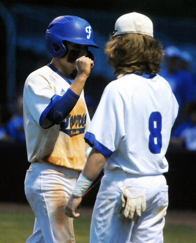 Andrew Timmons celebrates with Carter Walk after scoring Tuesday night&rsquo;s only run against Riverside.