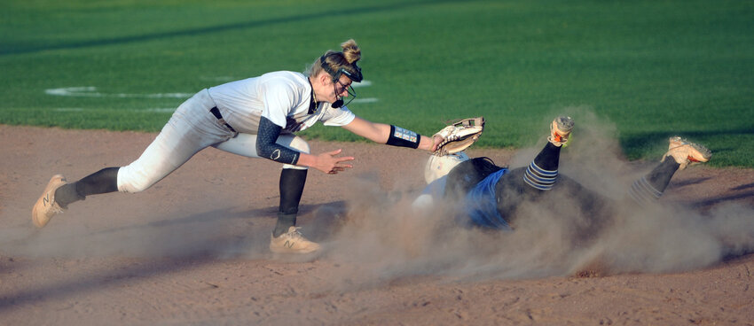 Kaniyah Taylor avoids the swipe by Lady &lsquo;Dawg short stop Alicia Polk and safely reaches second base.