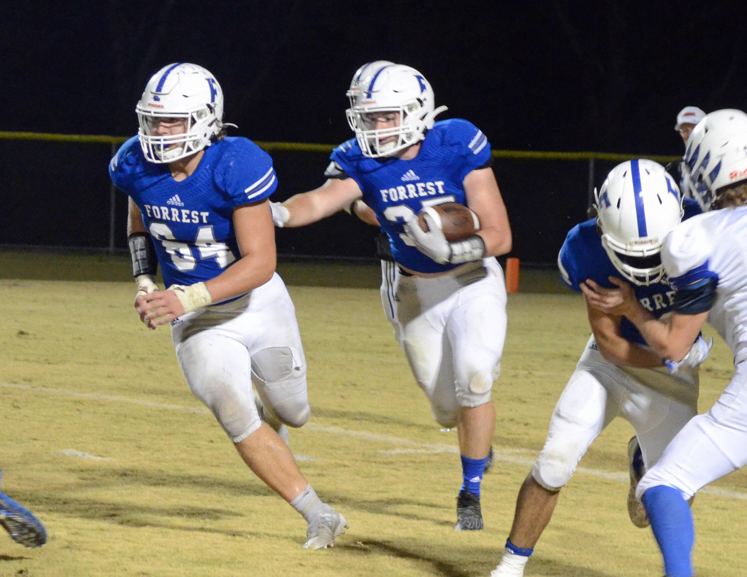 Forrest senior running back Joseph Whitaker (35), who had a career-high 118 yards on the ground, follows fellow senior Noah Hill (64) through a big hole in the Rockets’ dominating rushing performance versus the Eagles.