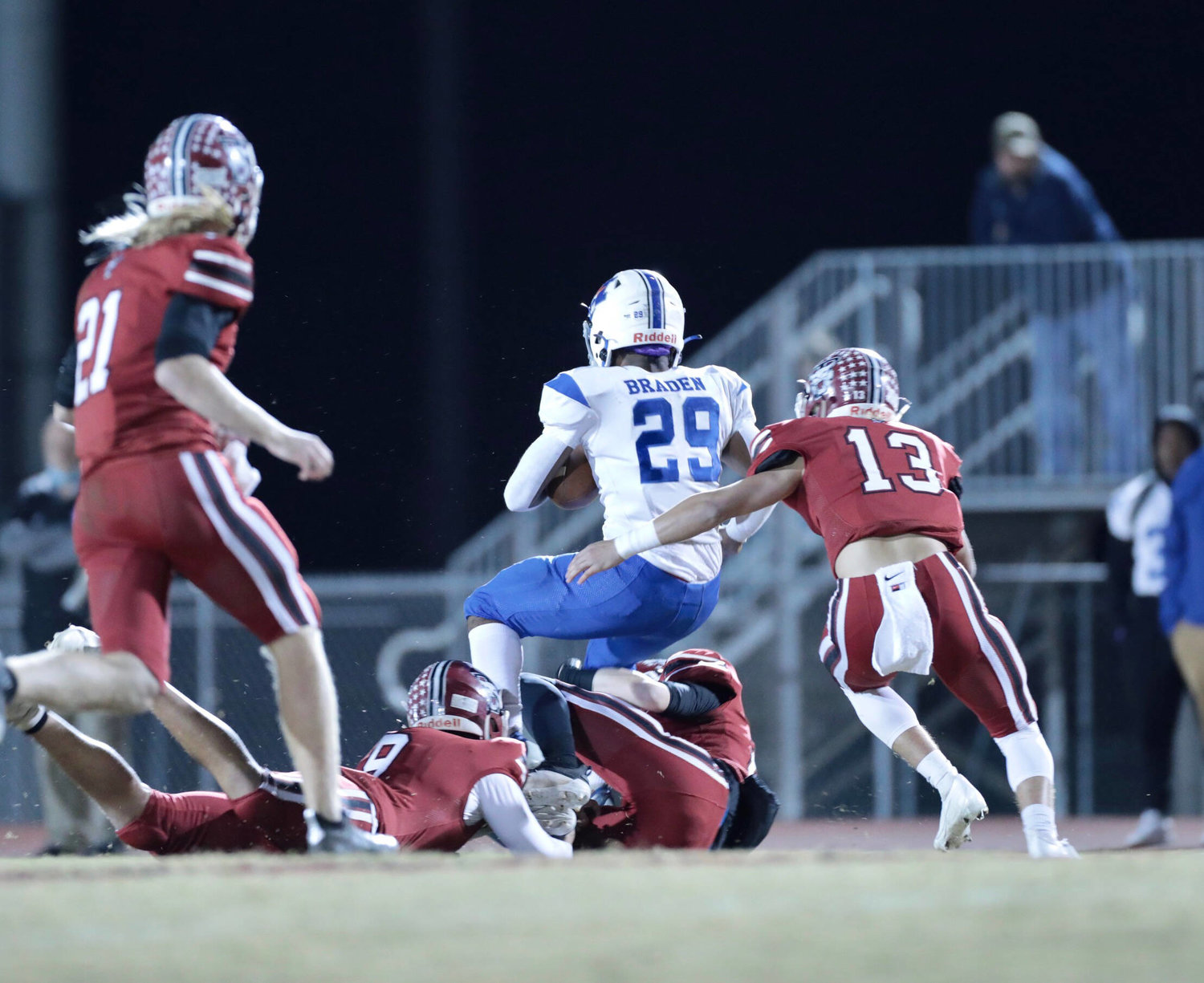 Demari Braden (29) tries to break out of a four-man Tullahoma tackle.