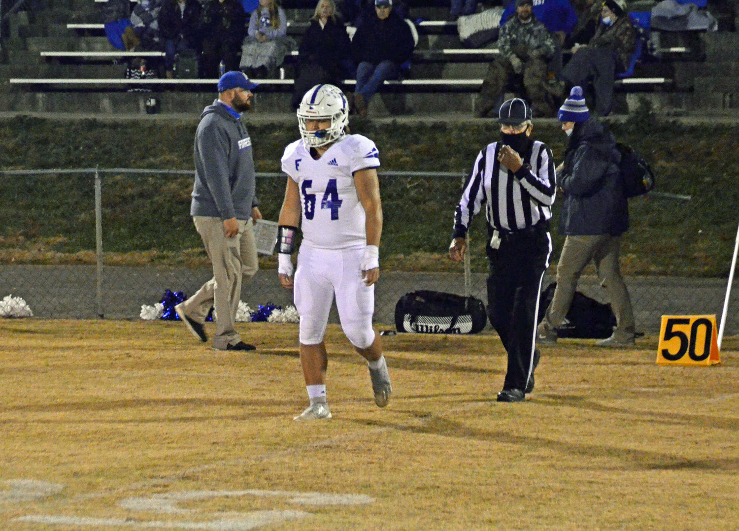 Forrest senior Noah Hill walks to the midfield for the opening coin toss for the last time as a Rocket captain.