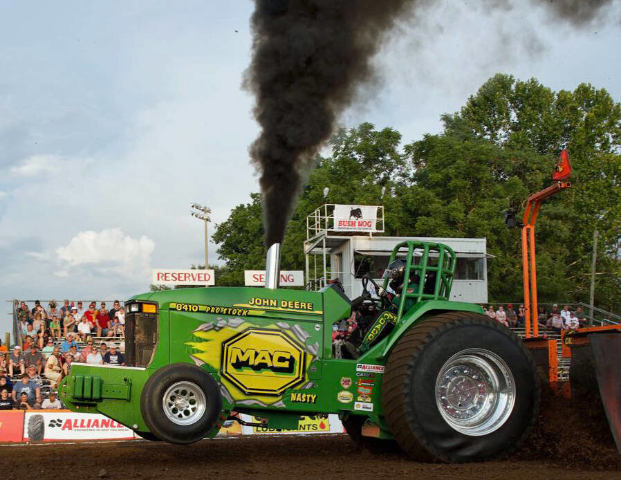 Beloit, Ohio’s Mike Conny and his MAC Nasty John Deere 8410 10,000 pound Pro Stock Tractor machine blows a full stack and gets its front wheels off the ground before roaring down the Lions Club Motorsports Park track in the 2019 Super Pull of the South.