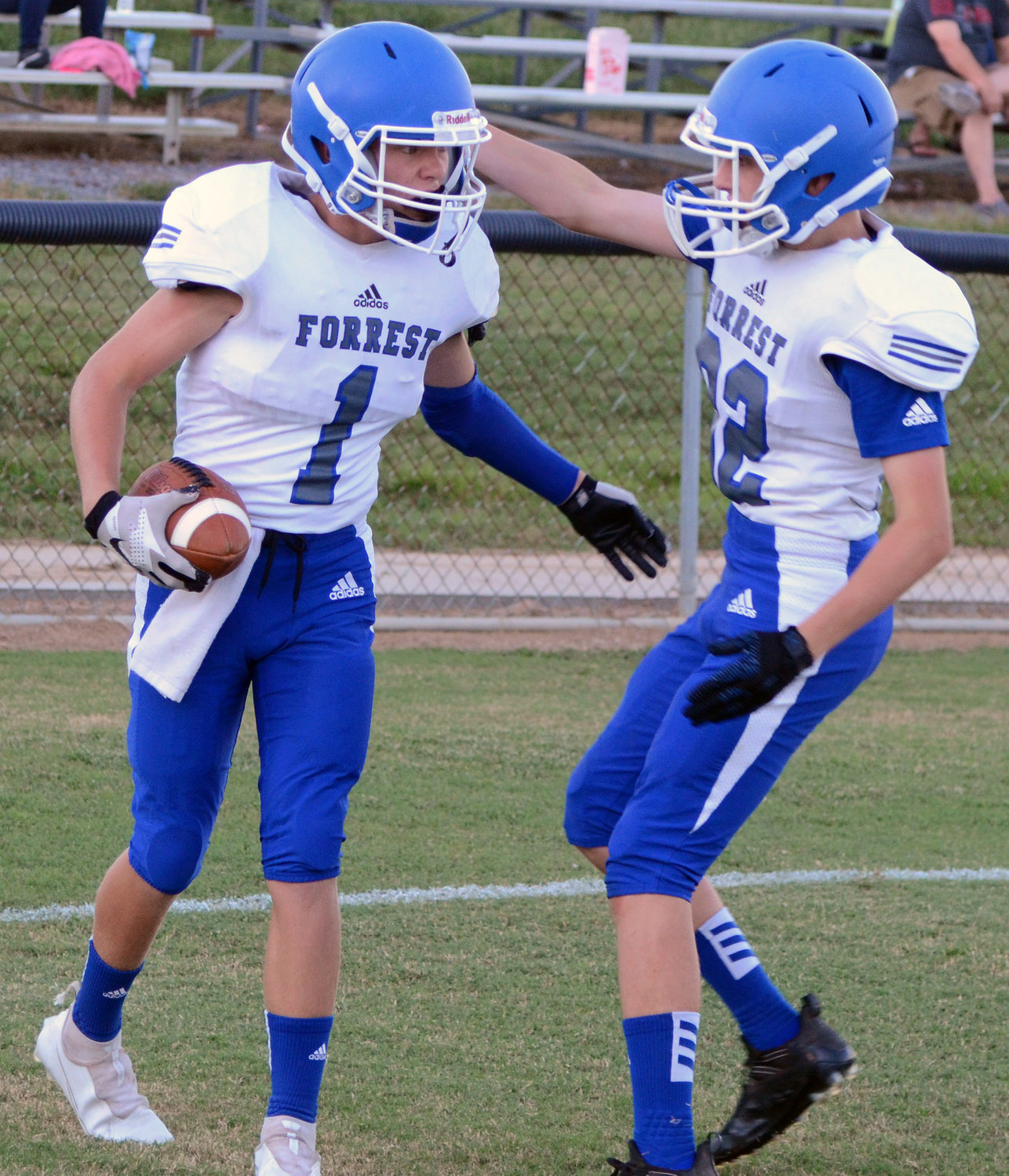Forrest seventh-grade standout Fletcher Fields (1) is congratulated by eighth-grade standout Eli Bell (22) after Fields came up with a pick-six on the second play of the game.
