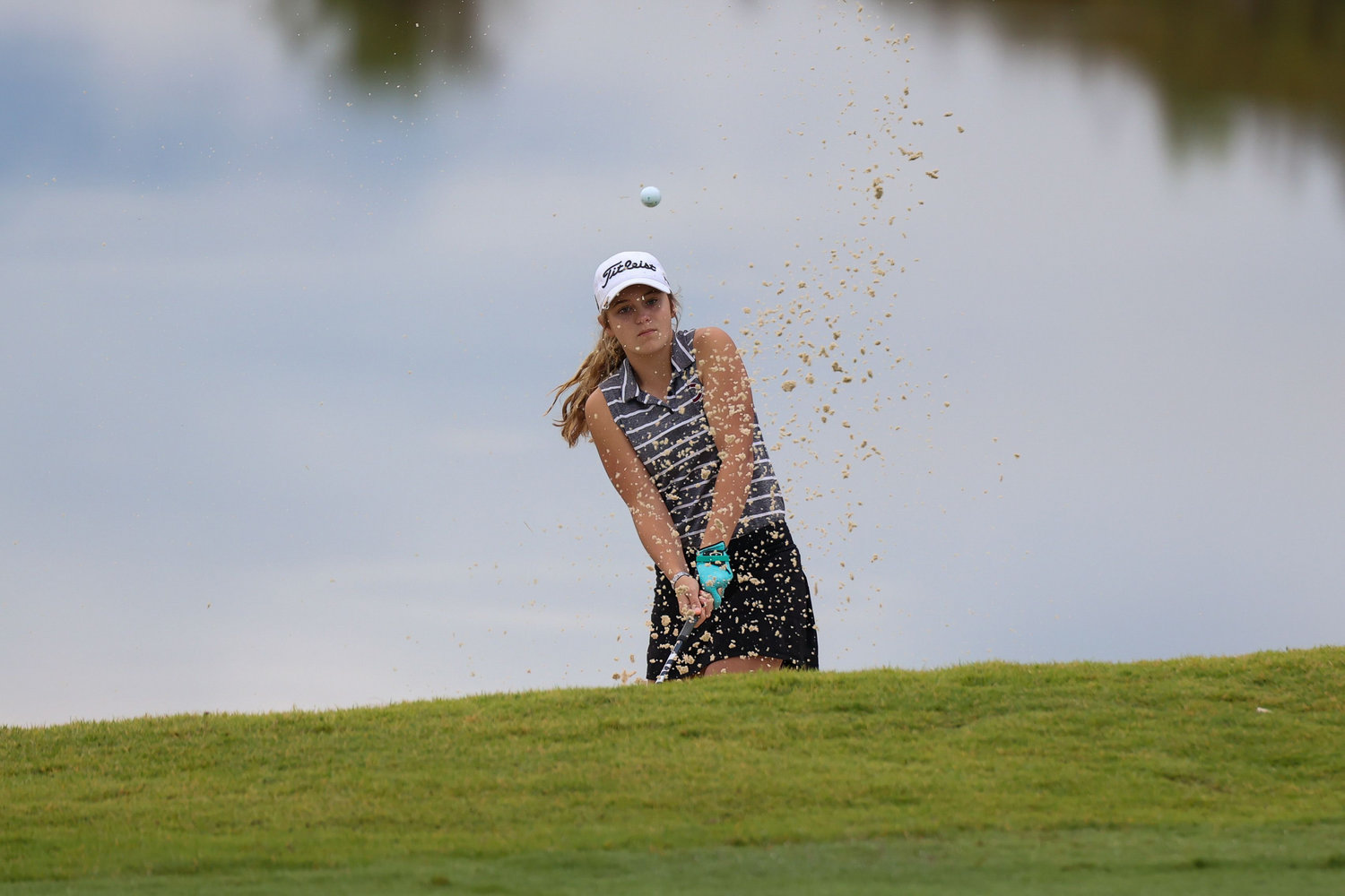 Annabelle Mulliniks hits out of a bunker at the scenic Sevierville Golf Club in East Tennessee.