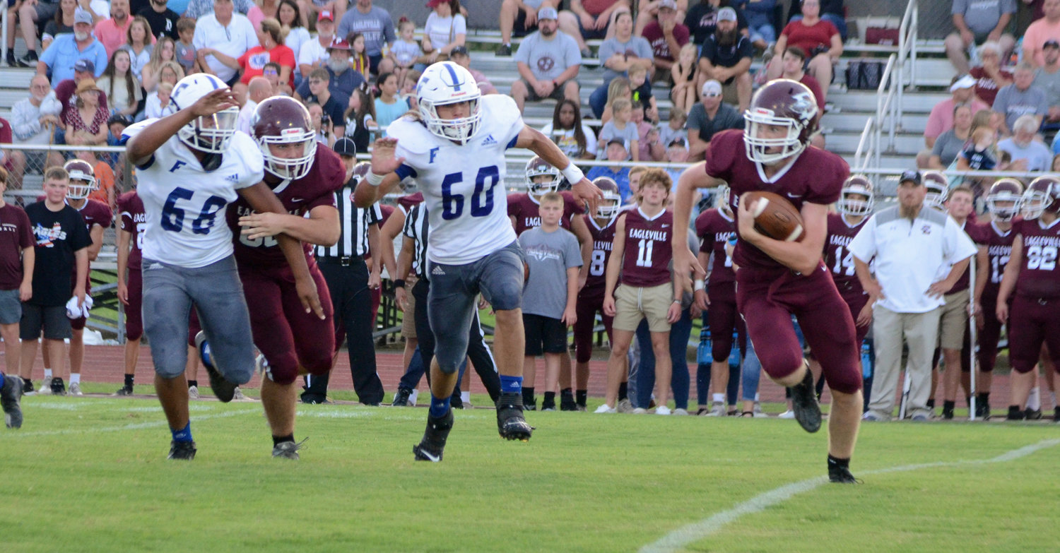 Sophomore Reggie Pearson (68) and senior Layne Strasser (60) chase down an Eagleville player in the season opener for the Forrest defense that has been a stingy unit the entire 2021 campaign.