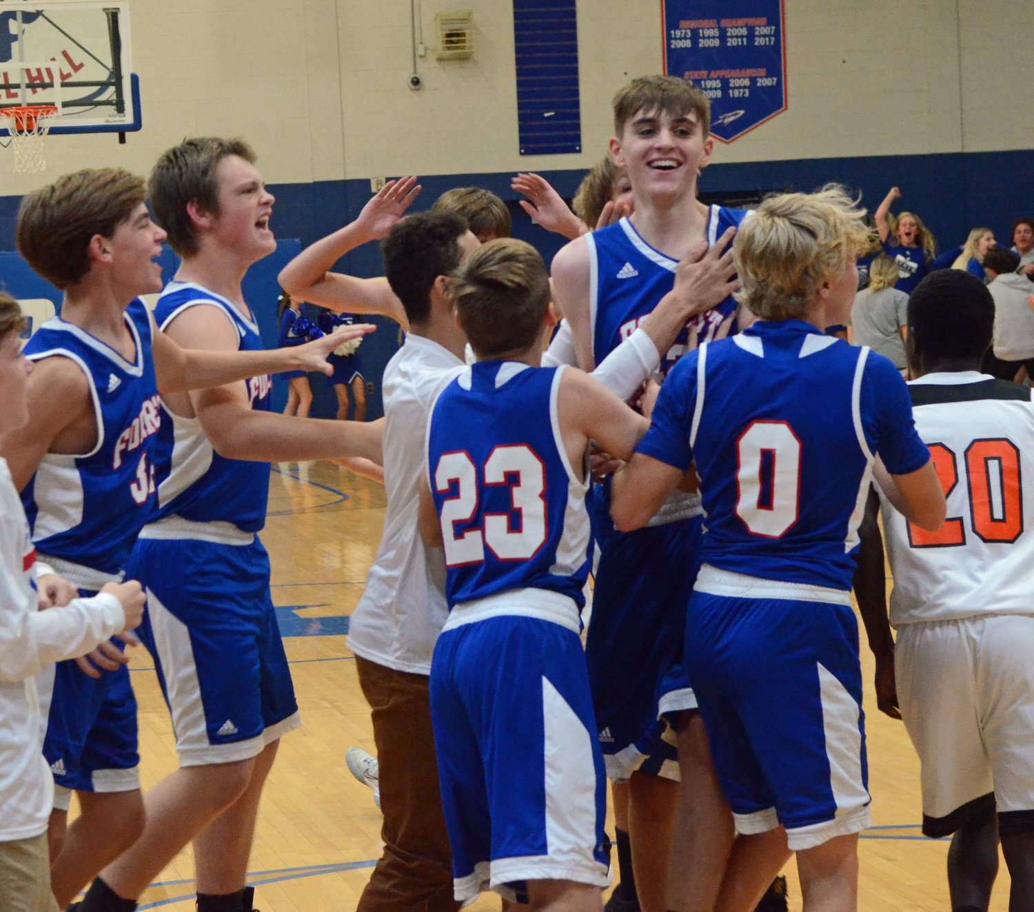 The Rockets mob Josh Doud after the eighth-grader made the game-winning basket.