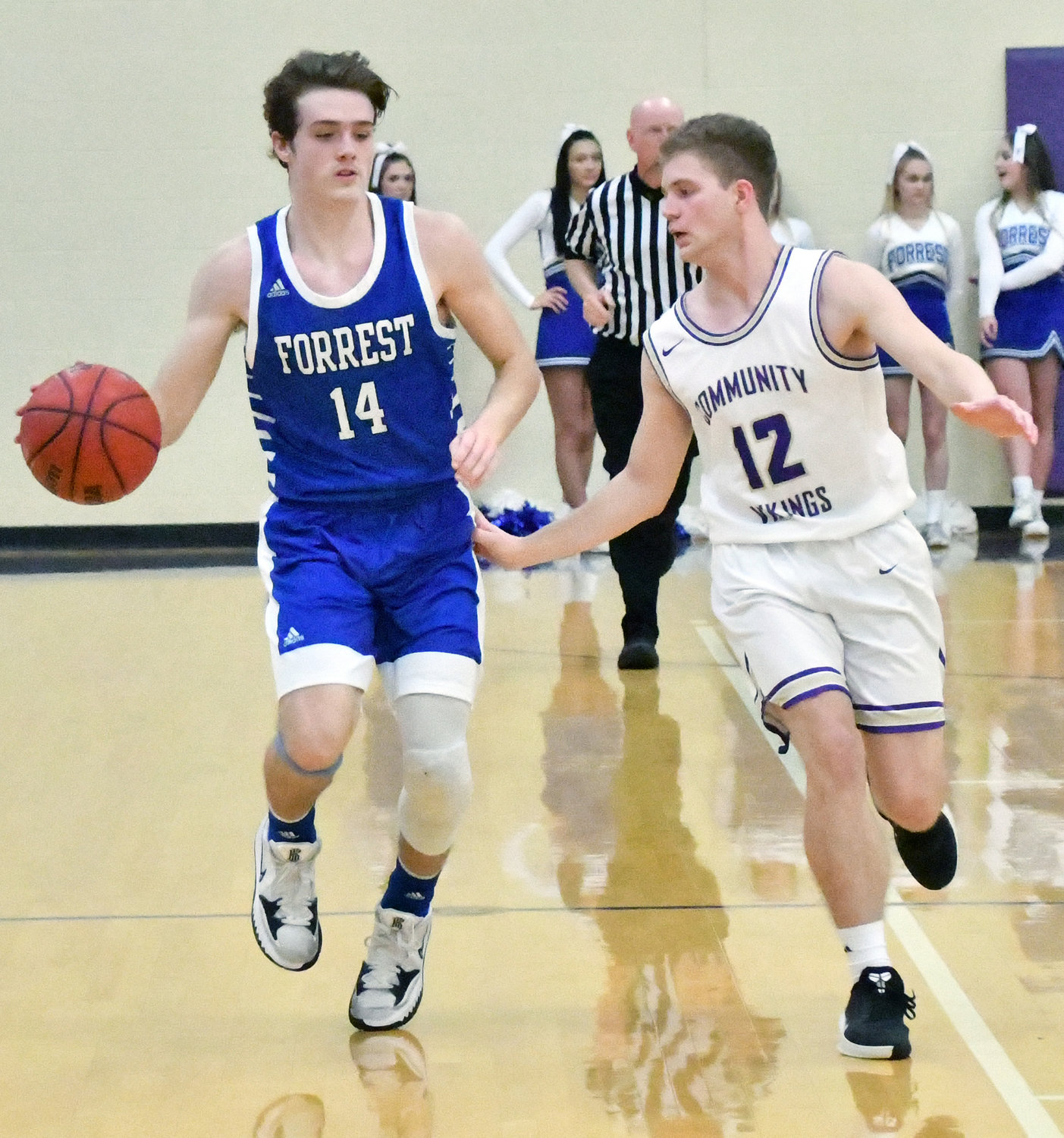 Hunter Bennett (14) brings the ball up the court for the Rockets.  Bennett led Forrest in scoring with 26 points.