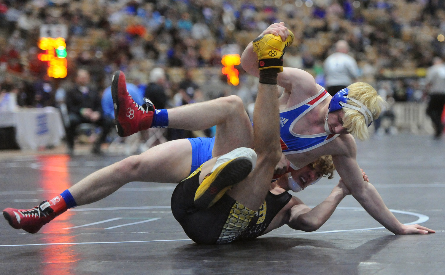 Seth McCoy repositions and goes in for the pin against Fairview’s Blake Mitchell in the opening round of the 145-pound weight class.
