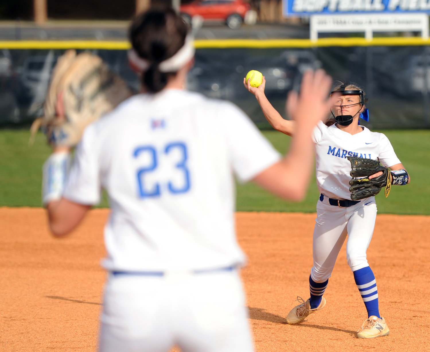 Second baseman Courtney Lynch fires the throw to first baseman Mallory Woodward for the out.