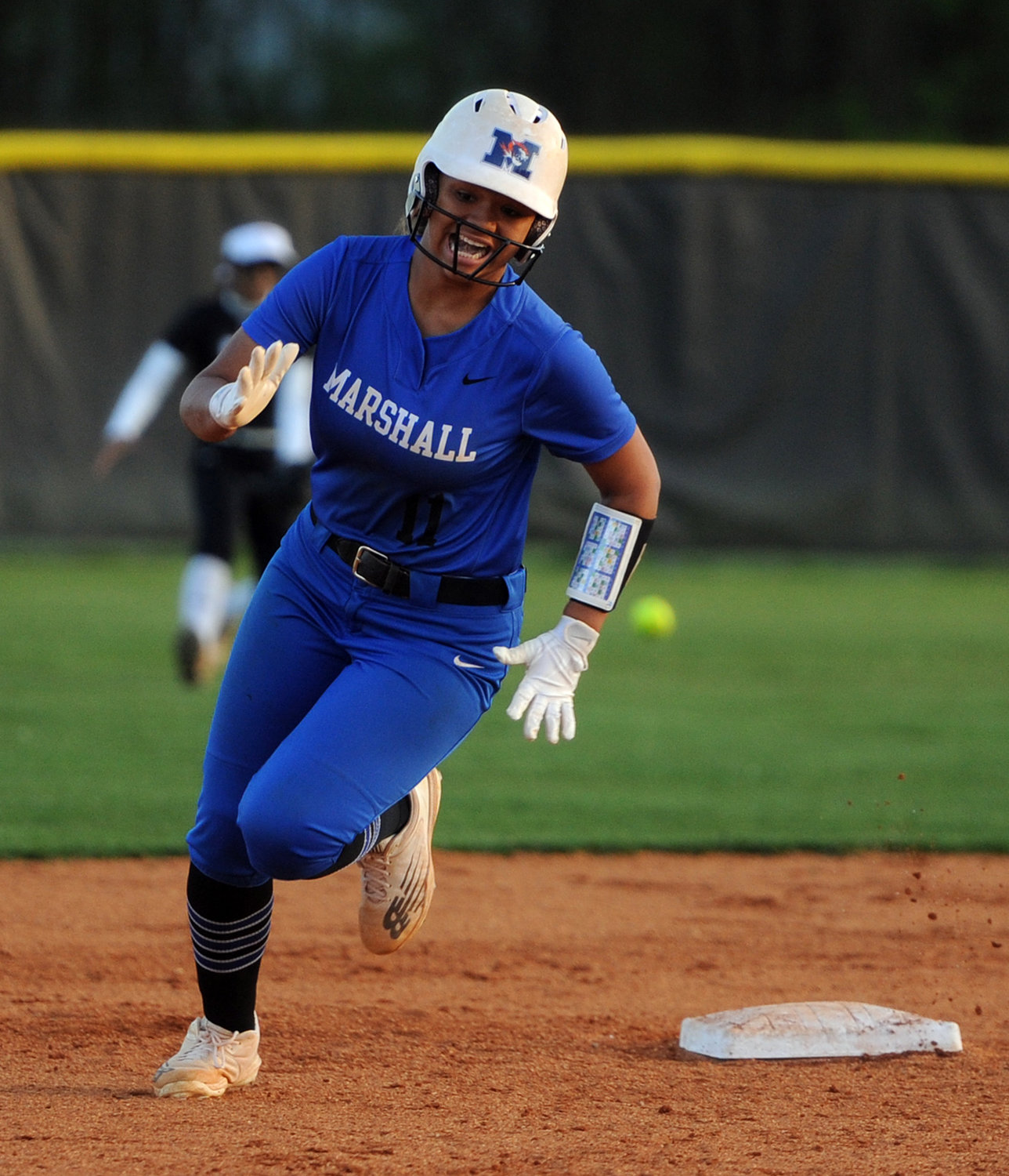 Demiyah Blackman rounds second and heads for third on a base hit.