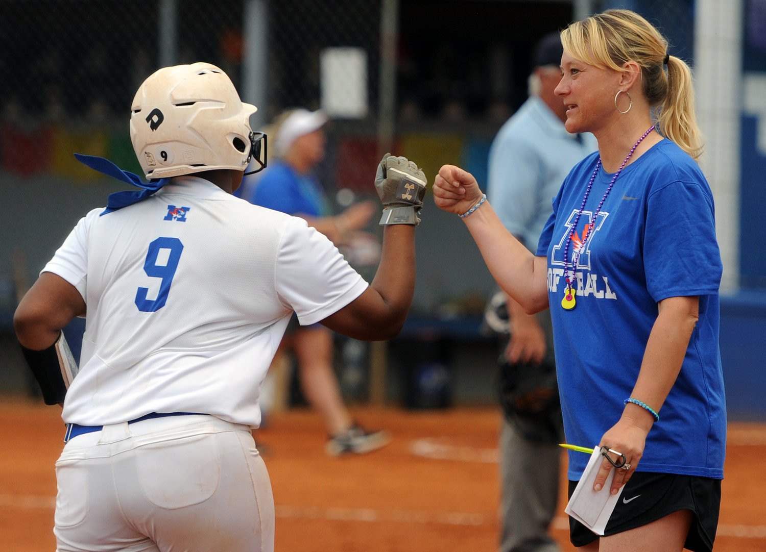Tigerette coach Amy Bonner catches a fist bump from Kaniyah Taylor as she rounds third after crushing a home run against Spring Hill.