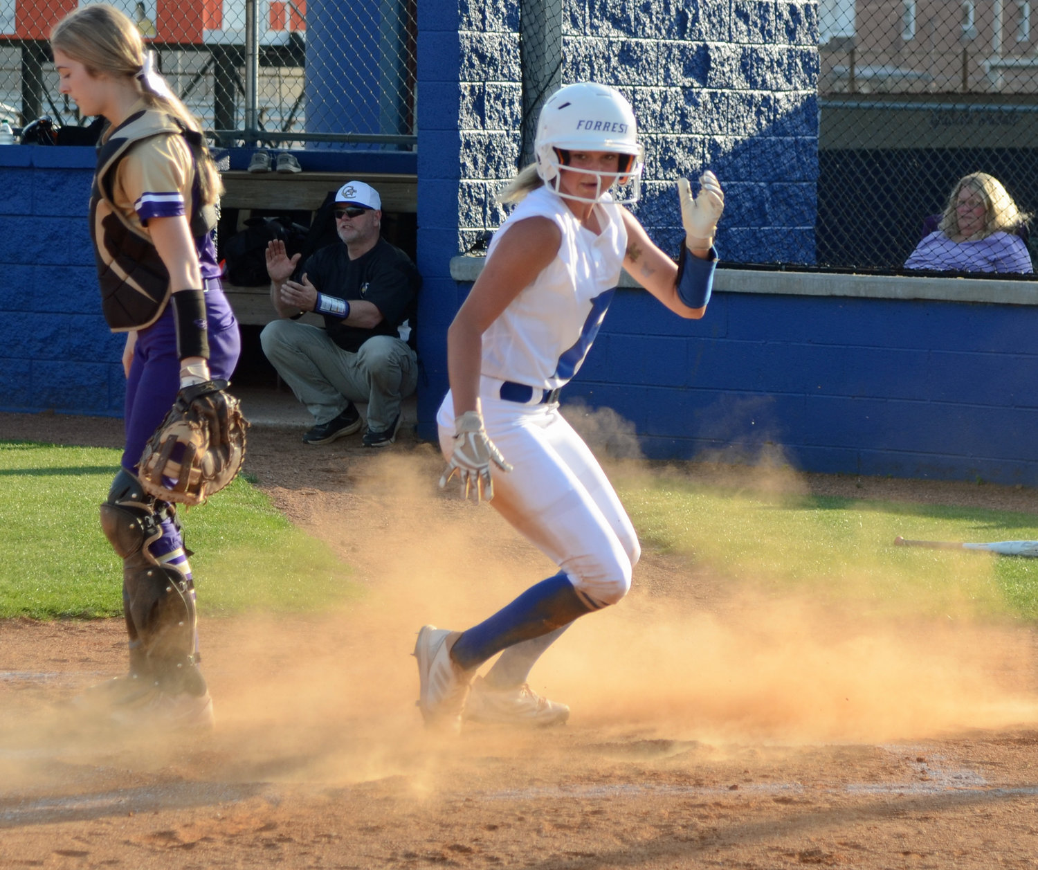 Macyn Kirby, who went 3-for-3, slides home to make it 1-0 in the bottom of the first inning.